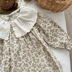 Discover the grace and elegance of our Cotton Floral Dress. Made from light cotton, this luxurious dress features long sleeves and a ruffled embroidered collar. The delicate floral print adds a touch of sophistication, making it the perfect choice for your little girl's special occasion attire. This dress runs big, we advise you to size down. Cotton Dress With Ruffled Collar For Garden Party, Long Sleeve Dresses With Lace Collar For Garden Party, Cottagecore Long Sleeve Dresses With Ruffles, Cream Long Sleeve Dress With Lace Collar, Long Sleeve Cottagecore Dress With Lace Trim, Spring Cream Dress With Peter Pan Collar, White Cotton Dress With Ruffled Collar, Cotton Dresses With Lace Trim And Ruffled Collar, Spring Long Sleeve Dress With Lace Collar