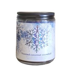 frosted coconut snowball candle in a glass jar on a white background with the label frosted coconut snowball