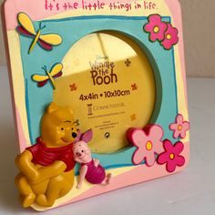 a winnie the pooh photo frame sitting on top of a table