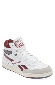 This street-ready mid-top sneaker has a basketball-inspired silhouette with a leather upper sporting suede details and an off-the-hardwood feel. Lace-up style Cushioned footbed Leather upper/synthetic lining/rubber sole Imported Reebok Bb 4000 Ii, Mid Top Sneakers, Sneaker Men, Mid Top, Up Styles, Mens Shoes Sneakers, Size 13, Rubber Sole, Men's Shoes