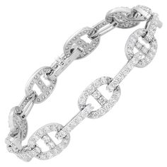 Introducing our exquisite 4.90 Carat Diamond Chain Link Bracelet in 18K White Gold. This bracelet is a true testament to luxury and sophistication. Featuring oval links encrusted with a magnificent 4.90 carats of diamond pave, it radiates brilliance and captivates attention. The chain link construction not only adds an elegant touch but also ensures extreme comfort, allowing the bracelet to drape effortlessly on your arm. Whether you want to make a bold statement or prefer a more subtle look, th Modern Bracelets, Diamond Chain, Chain Link Bracelet, Modern Jewelry, Pave Diamonds, Diamond White, Link Bracelets, Chain Bracelet, Chain Link