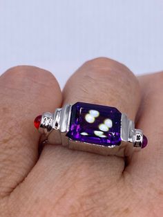 Vintage Handmade Genuine Purple Amethyst Filigree Setting 925 Sterling Silver Gothic Ring Unusual Amethyst  Ring set with tiny red crystals  Sterling Filigree Setting Handmade  Size 7.5 can be re sized for you.  My jeweler charges $20 Sterling Silver is rhodium finished to prevent tarnish All rings are shipped in a nice gift box.   Check out our over a THOUSAND great reviews Engraving is $4 per letter and is not always perfect depending on the piece. It can take a few days if the jeweler is busy Sterling Silver Jewelry With Rectangular Center Stone, Formal Spiritual Amethyst Ring, Classic Amethyst Multi-stone Rings, Collectible Garnet Gemstone Ring, Spiritual Formal Rings With Accent Stones, Formal Spiritual Rings With Accent Stones, White Gold Multi-stone Ruby Jewelry, White Gold Ruby Multi-stone Jewelry, Emerald Cut Ruby Ring With Multi-stone