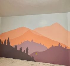 a bedroom with mountains painted on the wall and bed in foreground, there is a yellow light at the end of the room