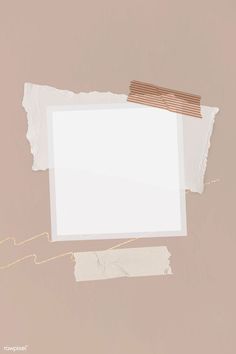 torn white paper with a brown ribbon on it and a piece of cardboard taped to the wall