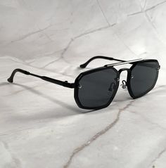 Embrace a bold and distinctive look with the octagonal black metal frame and black lenses. Introducing our Octagonal 70s Aviators -- a timeless fusion of vintage charm and contemporary style. Stand out from the crowd with a shape that exudes confidence and individuality. New old stock. Never worn. Great condition. UV Protection. NOS Deadstock Made in Europe FIT INFORMATION 55 mm Eye Size 16 mm Bridge 155 mm Temple/Arm Width 5 Inches Height 1 3/4 Inches Sunglasses Unique, 70s Sunglasses, Unique Sunglasses, Aviators Women, Black Aviators, Black Metal Frame, Eyewear Sunglasses, Vintage Charms, Black Metal