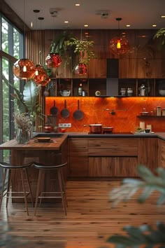 a kitchen with wooden floors and lots of plants on the counter top, along with hanging lights