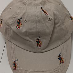 Polo Ralph Lauren Men's Khaki Beige All Over Logos Cap Hat Osfa Msrp $49 Nwt Brand New With Tags Never Worn 100% Guaranteed Authentic Polo Ralph Lauren Men's Khaki Beige All Over Logos Cap Hat Size - Adjustable Cloth Strap With "Polo" Metal Clasp - One-Size Fits All - Osfa Color - Khaki Beautifully Embroidered All Over "Polo Player/ Horses" Logos On Cap 100% Cotton Cotton Sweatband Msrp - $49.50 From Smoke-Free/Pet-Free Home Beige Hat With Embroidered Logo And Short Brim, Cream Casual Hat With Flat Bill, Casual Cream Flat Bill Hat, Casual Beige Flat Bill Hat, Casual Multicolor Hat With Embroidered Logo, Casual Khaki Baseball Cap With Short Brim, Casual Beige Flat Bill Baseball Cap, Horse Logo, Mens Khakis