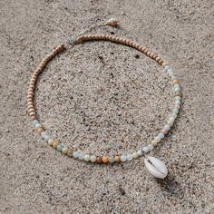 Originally founded as an arts colony, Laguna Beach is a mix of chill beach town and funky bohemian culture, offering some of the clearest blue water and the most relaxing days Southern California has to offer. MATERIALS blue and natural colored Amazonite with cowrie shell and natural wood on a 15" wire, finished with a 1.5" sterling silver extender chain with a ring clasp and tulip shell. Every stone is unique, which means that each bracelet is too. You can expect your jewelry to be one of a kin Beaded Cowrie Shell Jewelry, Shell Bracelet Diy, Hippie Jewelry Diy, Beachy Necklaces, Beach Style Jewelry, Wood Beads Jewelry, Bohemian Culture, Cowrie Shell Jewelry, Beachy Necklace