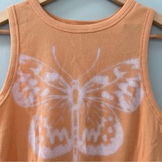 New Hollister Ribbed Orange Butterfly Tank Size Large Color: Orange, Peach Size: Large (L) Condition: New With Tags (Nwt) Adorable High Neck Crop Tank From Hollister. Casual Orange Seamless Tops, Orange Ribbed Tops For Spring, Orange Ribbed Summer Tops, Orange Butterfly, Hollister Tops, Pumpkin Orange, Crop Tank, Color Orange, Hollister