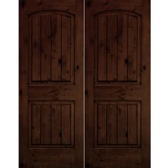 two brown doors with wooden panels on each side