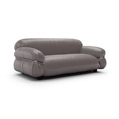 a gray leather couch sitting on top of a white floor