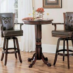 two brown leather bar stools sitting next to a small round table in front of a window