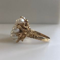 This is an awesome vintage 14K yellow gold and Pearl Ring. Casted form of real coral reef, holds 9 natural sea pearls, elegantly clustered together. Every side of this ring has beautiful details. A perfect gift for a June Birthday. Size 8.5 Metal: 14k yellow gold weight: 9.10g Every Antique piece of jewelry we sell at Heirloom Pavé has been checked for safety of each prong and repaired as needed. With any pre-owned/Vintage/Antique items, it is common to have some wear, As we inspect each piece o Pearl Ring Unique, Pearl Ring Gold, Precious Metal Clay Jewelry, 1970s Jewelry, Mermaid Ring, Vintage Gold Rings, Gold Pearl Ring, June Birthday, Metal Clay Jewelry