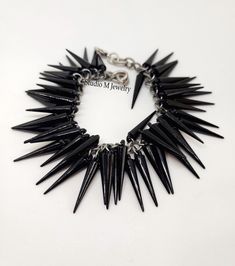 Black Spike Charm Bracelet, Goth Black Charm Bracelet, Punk Jewelry, Black Bracelet, Holiday Jewelry Gift, Antique Silver Jewelry 1" black, resin spike charm bracelet. Antique silver Lobster claw clasp closure and is 7.5" in length. #B77 Wanna See More? Click below for other items available: http://www.etsy.com/shop/StudioMJewelry Shipping: All jewelry pieces are ready to ship. Items are shipped to your Etsy address, via USPS First Class mail with tracking and delivery information. **Thanks for Antique Silver Jewelry, Black Bracelet, Punk Jewelry, Jewelry Black, Black Bracelets, Holiday Jewelry, Charm Bracelets, Jewelry Gift, Jewelry Pieces