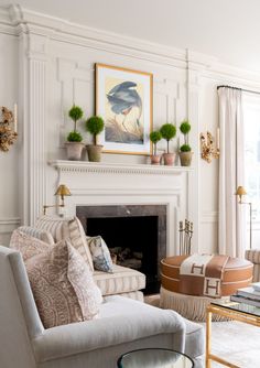 a living room filled with furniture and a fire place in front of a painting on the wall