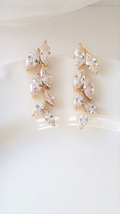 "Dainty and feminine, but with a lot of sparkle! This amazing pair of earrings feature shimmering 1 1/2\" long clear leaf marquise drops set in either a gold color, rose gold color or silver color finish. Select your finish at checkout. The earwire is a post/stud. Lightweight for all day comfort! Total earring length including the earwire approx: 1 1/2\" Width: 1/2\" MORE BRIDAL EARRINGS IN MY SHOP https://www.etsy.com/shop/Uniquebeadables?section_id=11352280&ref=shopsection_leftnav_5 BRIDAL Gold Marquise Earrings For Party, Gold Marquise Diamond Earrings For Wedding, White Marquise Earrings For Wedding, White Marquise Wedding Earrings, Vine Bracelet, Rose Gold Bridal Earrings, Gold Bridal Earrings, Rose Gold Bridal, Elegant Bracelet