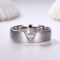 a white gold wedding band with an arrow design