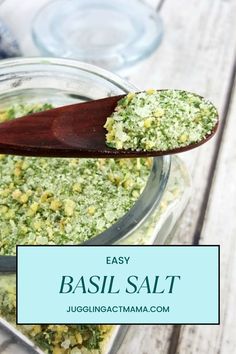 an easy basil salt recipe in a glass bowl with a wooden spoon on the side