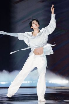 a woman in white is dancing on stage