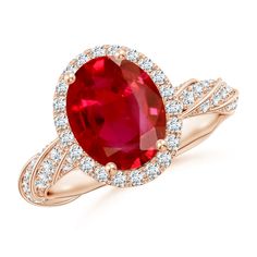 an oval shaped ruby and diamond ring in rose gold with diamonds around the shans