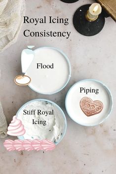 three bowls with different types of icing in them on a white surface next to candles and napkins