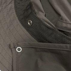 the back pocket of a jacket with an open zipper and two small buttons on it