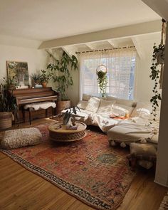 a living room filled with furniture and a piano in the corner on top of a rug