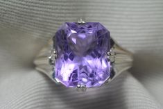 "The amethyst in this ring is set in such a way that it will touch the skin of the person wearing the ring.  Perfect for anyone wanting to wear amethyst for it's metaphysical properties.  This ring contains a genuine earth mined amethyst. The amethyst is a fabulous purple colour and has been precision cut. The precision faceting that the master cutter did when working with this amethyst has turned this gem into a piece of art. The reflection of light in this masterpiece forms a beautiful pattern that is hard to capture in pictures.   This size 6 1/2 ring is made of solid sterling silver and can be sized up or down by as much as 2 sizes for $25. This item is brand new and was appraised by a gemologist at Canadian Federal Gemological Laboratory of Canada.  The appraisal will be included with Elegant Octagon Amethyst Ring For Formal Occasions, Timeless Purple Gemstone Rings, Elegant Purple Sapphire Solitaire Ring, Elegant Purple Solitaire Sapphire Ring, Classic Purple Sapphire Ring For Wedding, Classic Purple Sapphire Wedding Ring, Octagon-shaped Amethyst Ring For Formal Occasions, Octagon Amethyst Ring For Formal Occasions, Octagon Amethyst Ring For Formal Events