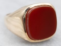 "Substantial and striking, this could be a great piece for a man or a woman! The style has clean lines that keep the ring simple! The center is a smooth and warm Carnelian, which has a lovely orange-red hue! Metal: 10K Yellow Gold Gem: Carnelian  Gem Measurements: 14.6 mm, Square Cushion Cut Ring Size: 8.75 Marks: \"10K W\" Stamped on the inside band To view a video of this piece check out the link below: https://vimeo.com/818890333 SKU #: A25241 Each piece has been identified and graded by a Gr Formal Carnelian Signet Ring With Polished Finish, Classic Carnelian Signet Ring With Polished Finish, Classic Carnelian Signet Ring For Formal Occasions, Classic Carnelian Signet Ring For Formal Events, Formal Red Carnelian Signet Ring, Classic Carnelian Rings With Polished Finish, Classic Orange Rings With Polished Finish, Red Carnelian Signet Ring With Polished Finish, Red Carnelian Ring With Polished Finish