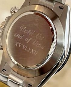 a close up of a wrist watch with writing on it