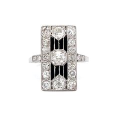 Vintage Art Deco Diamond Dinner Ring in Platinum This antique Art Deco cocktail ring is a timeless treasure! Crafted in platinum, the ring features a stunning old European cut diamond at the center. On either side of the main stone are two (2) old European diamonds, each measuring 3.35mm and weighing .15 carats. The sleek band features a geometric design and an onyx inlay for added contrast. Perfect for those who appreciate classic beauty and luxury. PRIMARY STONE Stone: Natural Diamond Shape: O Engagement Ring Style Guide, Ring Style Guide, Art Deco Cocktail, Jewelry Style Guide, Dinner Ring, Platinum Rose Gold, Sapphire Solitaire, Metal Shop, Pave Ring