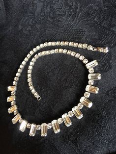 "Simple, classy & elegant Bridal Jewelry. Stunning piece for a Wedding! Authentic faceted Clear Rhinestone Necklace by Albert Weiss. Vintage 1942-1971. Signed on back of closure. Top of closure has 2 small rhinestones. Approximate measurements: 14.5\" long. Excellent vintage condition. No missing stones. International Shipping Insurance provided. A Hendersonville, NC estate find. #R2015-R9 Vintage, Home & Gifts www.MyVintageAlcove.etsy.com <-------- Shop the collection Shelf 7. Row 3. Luxury Vintage Rhinestone Necklaces, Glamorous Adjustable Rhinestone Necklace For Formal Events, Formal Bridal Necklace With Rhinestones, Classic Round Crystal Rhinestone Necklace, Retro Rhinestone Jewelry For Gifts, Adjustable Silver Jewelry For Vintage Events, Vintage Rhinestone Adjustable Necklace, Antique Rhinestone Necklaces For Formal Occasions, Classic Round Rhinestone Necklace For Anniversary