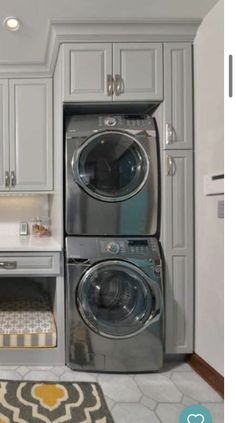 a washer and dryer sitting in a kitchen next to each other on the floor