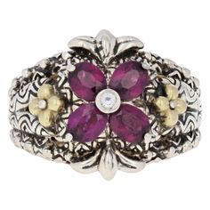 Turn heads your way when you accessorize with this stunning designer ring! Created by Barbara Bixby in sterling silver with accents of 18k yellow gold, the ring showcases a genuine white topaz solitaire and four natural Rhodolite garnets. Textured gold flowers, polished silver beads, and decorative detailing on the sides of the band add to the ring's exotic look. This ring is a size 7. Metal Content: Guaranteed Sterling Silver & 18k Gold as stamped Stone Information: Genuine Rhodolite Garnets Ge White Sapphire Ring, White Topaz Rings, Rhodolite Garnet, Garnet Rings, Gold Texture, White Sapphire, Gold Flowers, Topaz Ring, White Topaz