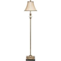 a floor lamp with a white shade on it