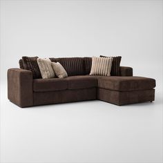 a brown sectional sofa with pillows on it's back and side facing the couch