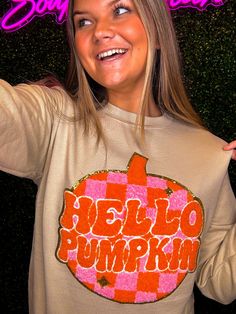 Welcome the season of pumpkin spice with the Hello Pumpkin Chenille Sweatshirt! This comfy crewneck sweater is crafted from cozy chenille fabric and decorated with bright orange and pink. It’s perfect for fall, and everybody needs one! You’ll be the cutest one this season! So what are you waiting for? Get yours now! Unisex sizing and fit SPECIAL CARE - WASHING INSTRUCTIONS: Hand washing and air drying are always best for these items. Wash on delicate, cold, and inside out. Always air dry to prev Trendy Orange Sweatshirt For Fall, Pink Graphic Print Fall Sweater, Pink Graphic Print Sweater For Fall, Fall Cotton Orange Sweater, Cute Graphic Print Sweater For Fall, Cute Orange Fall Top, Cute Orange Fall Tops, Orange Cotton Sweatshirt For Fall, Cute Orange Top For Fall