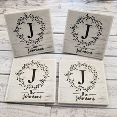 four coasters with the names of three different families and their initials are on top of each other