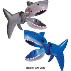 three plastic shark toys are in the shape of teeth