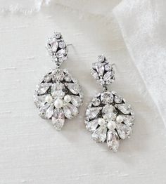 the bride's earrings are adorned with swarong crystal and pearl beads,