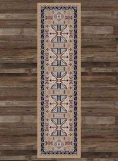 a beige rug with blue and red designs on the bottom, along with wood flooring