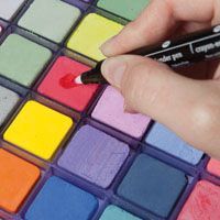 a person is using a marker to color the squares