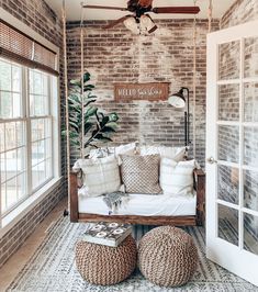 a living room filled with furniture and brick walls