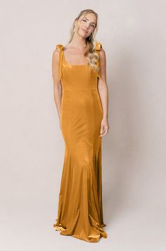 Model: Britt; Size: 4; Color: Mustard Square Neck Dress With Ruched Back And Fitted Bodice, Gala Maxi Dress With Fitted Bodice And Square Neck, Elegant Midi Dress With Ruched Back And Square Neck, Elegant Midi Dress With Square Neck And Ruched Back, Formal Maxi Dress With Square Neck In Solid Color, Elegant Square Neck Midi Dress With Ruched Back, Formal Maxi Dress With Square Neck, Party Dress With Square Neck And Bias Cut, Party Dresses With Bias Cut And Square Neck