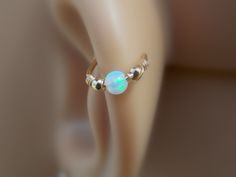 This listing is for one small 14K gold filled hoop with tiny gold filled beads and synthetic opal gemstone bead wrapped with gold filled wire. This is a non pierced handmade helix/nose/septum cuff. No piercing is required for this helix cuff. Size: Thickness 20 gauge=0.8mm Diameter:7mm/8mm(standard)/9mm/10mm ★PLEASE NOTE: All pieces are created by hand, so there can be a slight difference between 2 pieces. Please allow for slight differences from what is shown in the photos. Please see my shop f Hypoallergenic Adjustable Septum Ring For Weddings, Tiny Adjustable Septum Ring As Gift, Adjustable Stackable Cartilage Earrings, Dainty Adjustable Septum Ring Gift, Dainty Adjustable Tiny Septum Ring, Adjustable Dainty Septum Ring Gift, Adjustable Dainty Septum Ring, Dainty Adjustable Hypoallergenic Body Jewelry, Adjustable Dainty Round Septum Ring