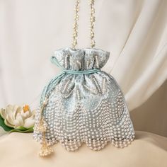 "Fancy Pearl Bead Embroidery Satin Wedding Purse Bag for Woman | Bridal Sky-Blue Purse Handbag | Fashionable Drawstring Pouch Purse Potli Bag Package Contents: 1 Size: 10\" x 8\" Designed with the heart, this beautiful Potli or batawa bag are eye catchy and made of premium material. Key Features: Embroidery art work. (zardosi work). This potli is good match with both Indian and western outfits and are superb for wedding and festive parties. This would be best complement to your designer saree, lenhga or any other kind of dress. This is the combination of traditional and modern embroidery work. This is enough to keep your accessories and all needed essentials and it can be a best gift for any woman." Festive Beaded Handheld Bags, Silver Embroidered Bag For Gift, Silver Embroidered Bags Suitable For Gifts, Festive Beaded Shoulder Bag For Wedding, Silver Embroidered Bags As Gift, Festive Embellished Pouch Bag, Beaded Pouch Potli Bag, Embellished Pouch Bag For Reception, Elegant Handheld Embroidered Pouch