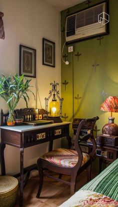 a bedroom with a bed, desk and air conditioner on the wall next to it