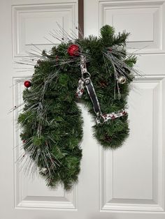 a wreath is hanging on the front door