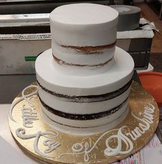 a three tiered cake sitting on top of a gold plate