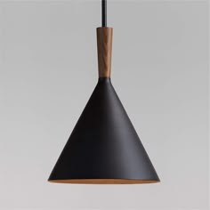 a black and wood light hanging from a ceiling fixture with a wooden handle on the end